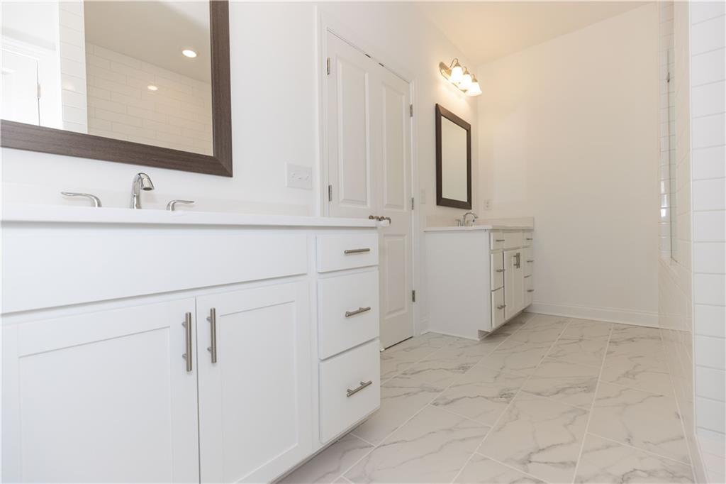 4912 Molder Avenue, Unit 66 Buford, GA 30518 - Photo 37 of 83 a bathroom with a sink vanity and mirror