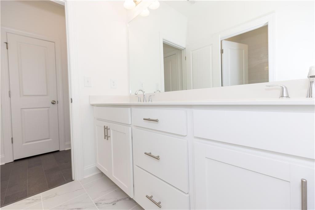 4912 Molder Avenue, Unit 66 Buford, GA 30518 - Photo 39 of 83 a bathroom with a sink and a mirror