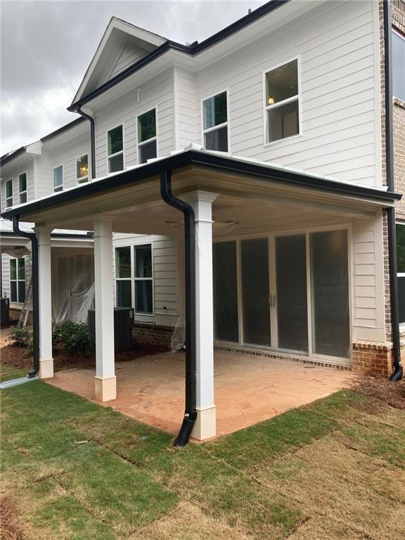 4912 Molder Avenue, Unit 66 Buford, GA 30518 - Photo 45 of 83 a front view of a house with a yard and garage