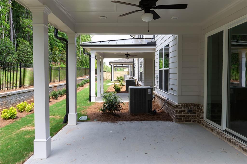 4912 Molder Avenue, Unit 66 Buford, GA 30518 - Photo 46 of 83 a view of a porch with furniture and floor to ceiling window
