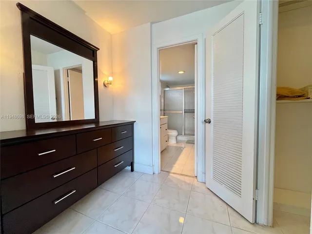 a room with a bed and a mirror