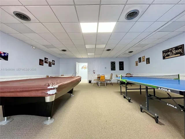 a room with furniture and pool table
