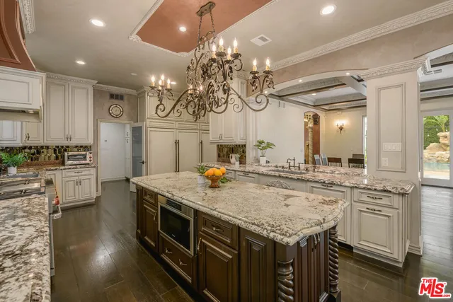 a kitchen with stainless steel appliances granite countertop a stove and cabinets
