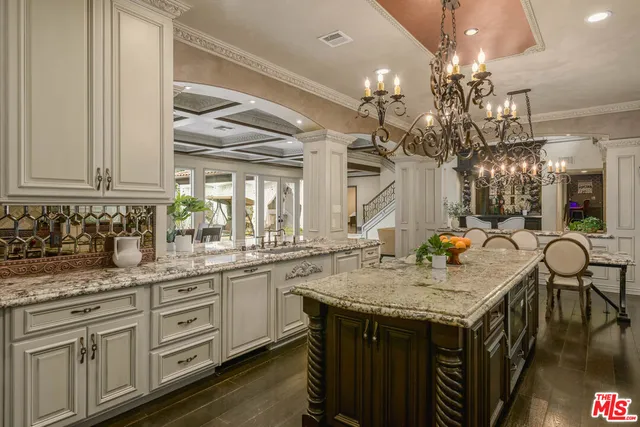 a kitchen with center island and chandelier