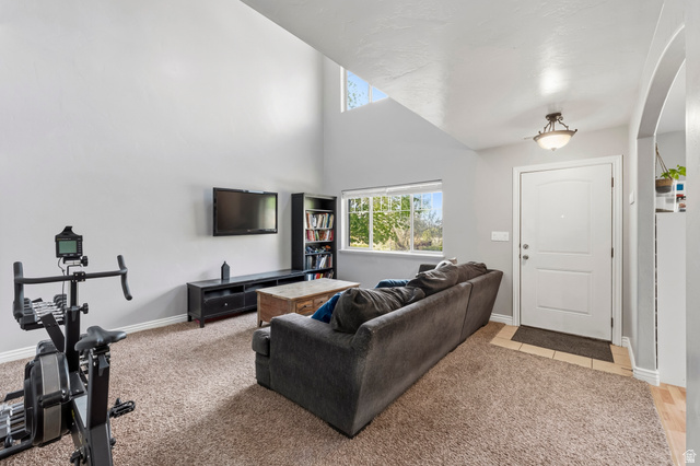 1165 West 100 South Springville, UT 84663 - Photo 10 of 28 Living room with a high ceiling, healthy amount of natural light, and light carpet