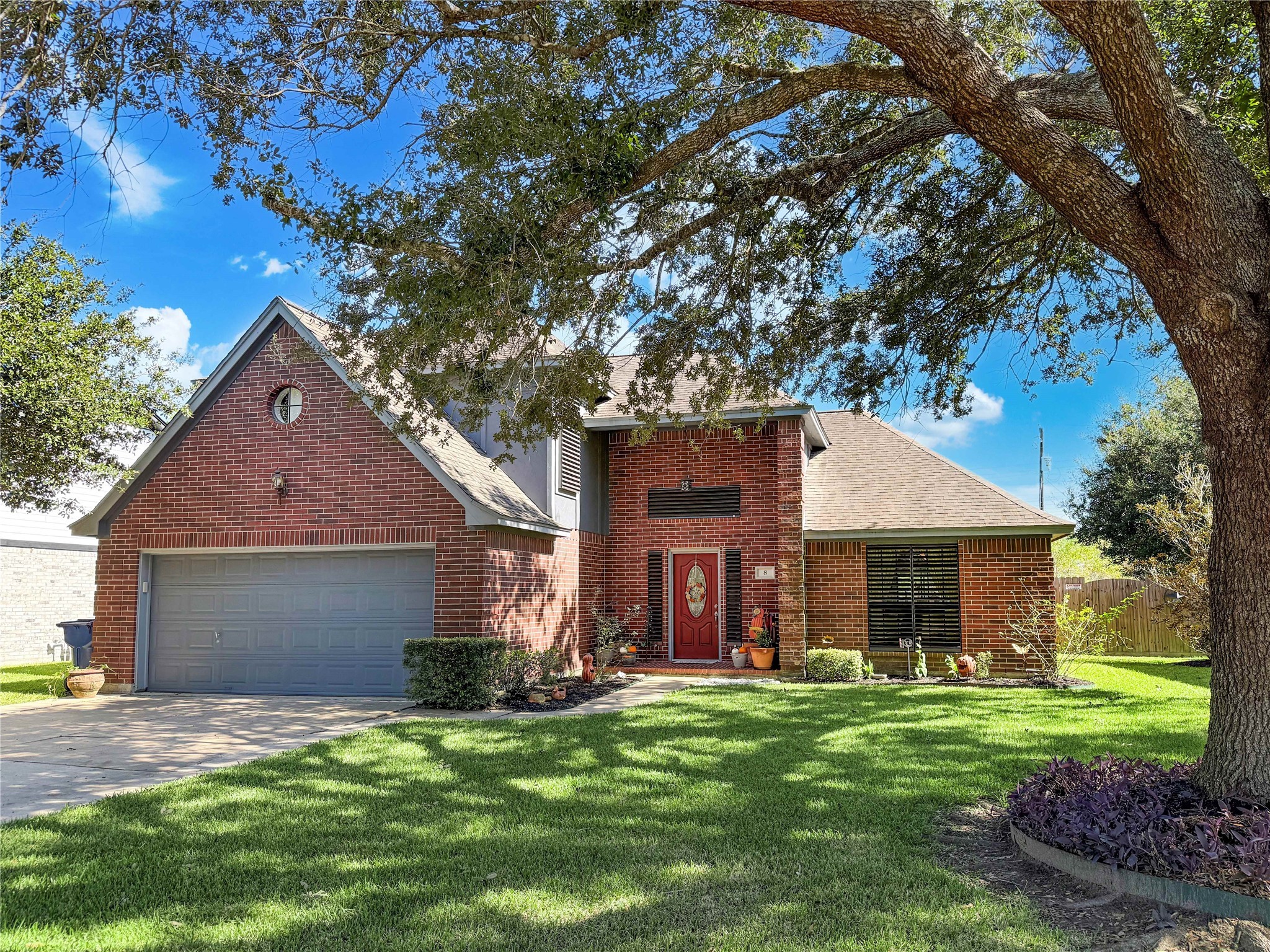 8 Rayburn Ridge Angleton, TX 77515 - Photo 1 of 22 a front view of a house with a garden and yard