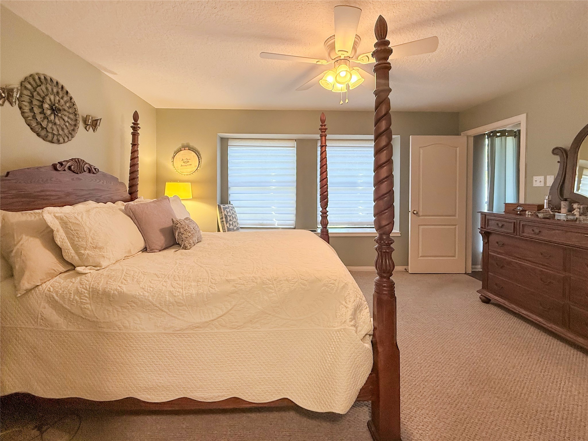 8 Rayburn Ridge Angleton, TX 77515 - Photo 14 of 22 a bedroom with a bed and a chandelier
