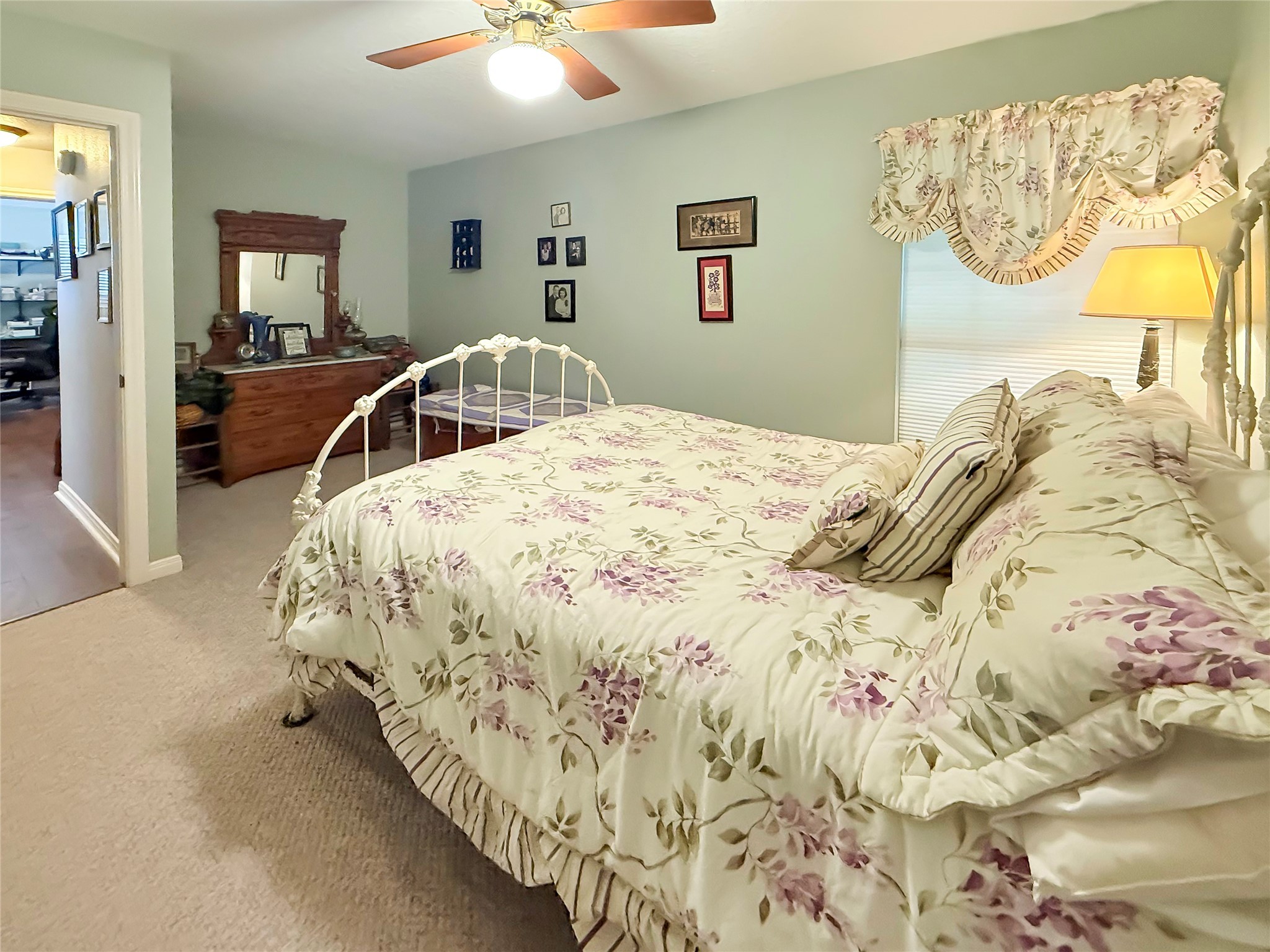 8 Rayburn Ridge Angleton, TX 77515 - Photo 19 of 22 a bedroom with a bed and a chandelier