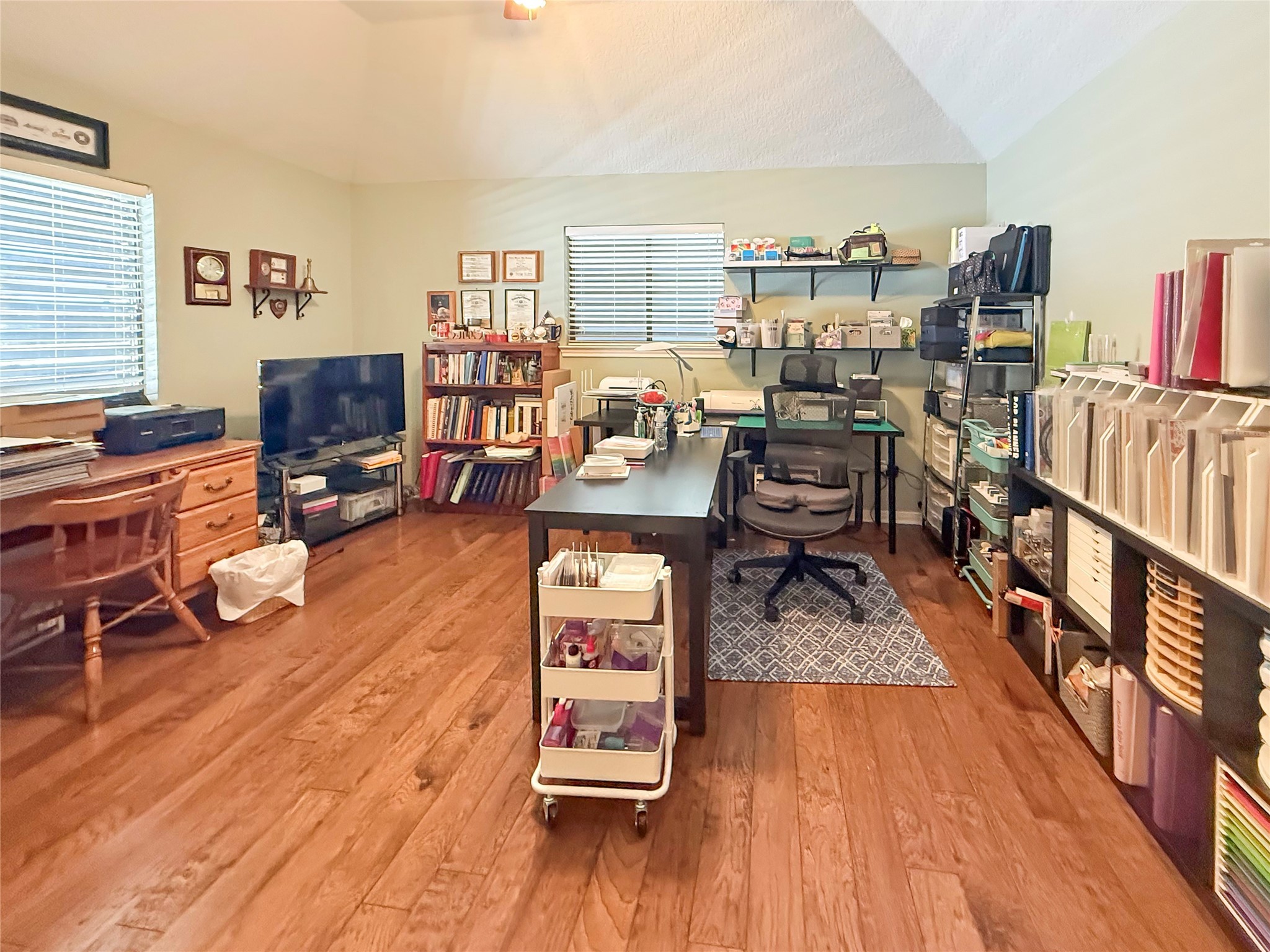 8 Rayburn Ridge Angleton, TX 77515 - Photo 20 of 22 a view of a livingroom with furniture hardwood floor and a flat screen tv