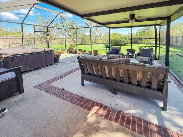 a living room with a large window and furniture