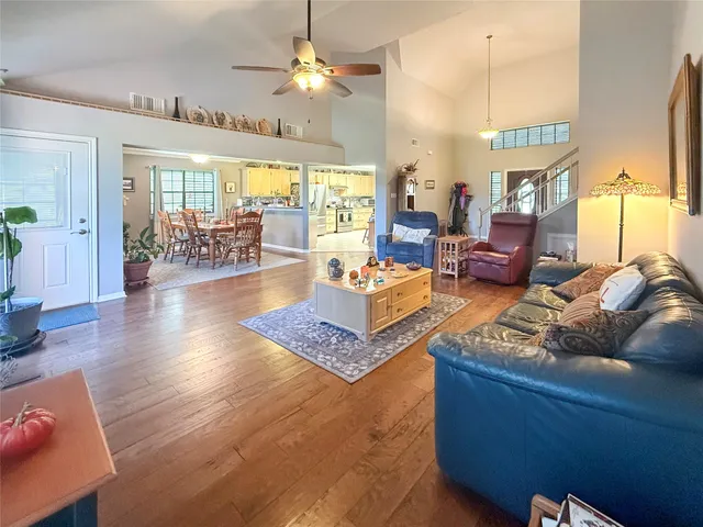 a living room with furniture a chandelier and a table