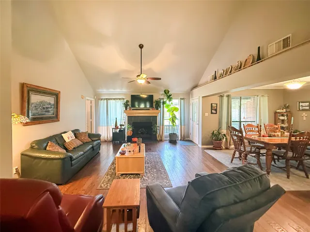 a living room with furniture a fireplace and a chandelier