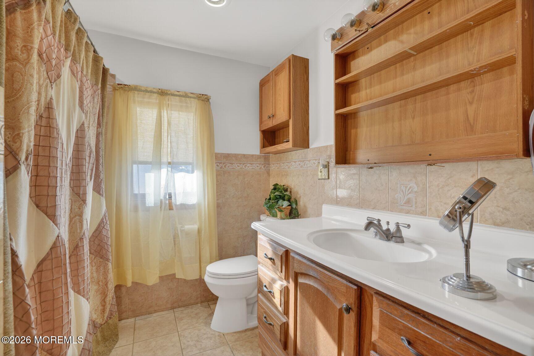 9 Hurley Street Keyport, NJ 07735 - Photo 16 of 22 a bathroom with a sink a toilet and shower