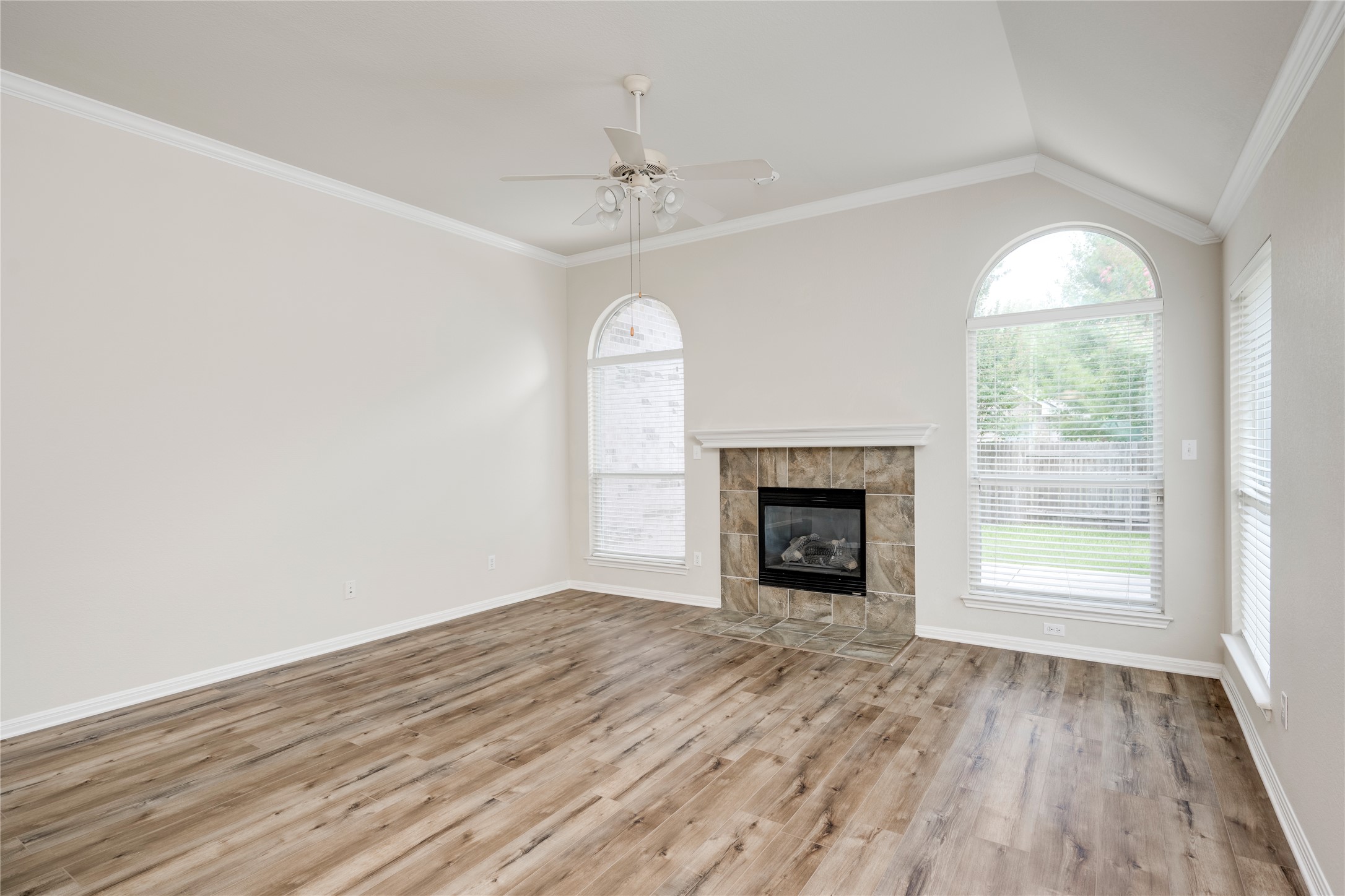 1813 Nelson Ranch Loop Cedar Park, TX 78613 - Photo 14 of 39 A well-lit living area features high vaulted ceilings and a gas fireplace, perfect for cozy gatherings.