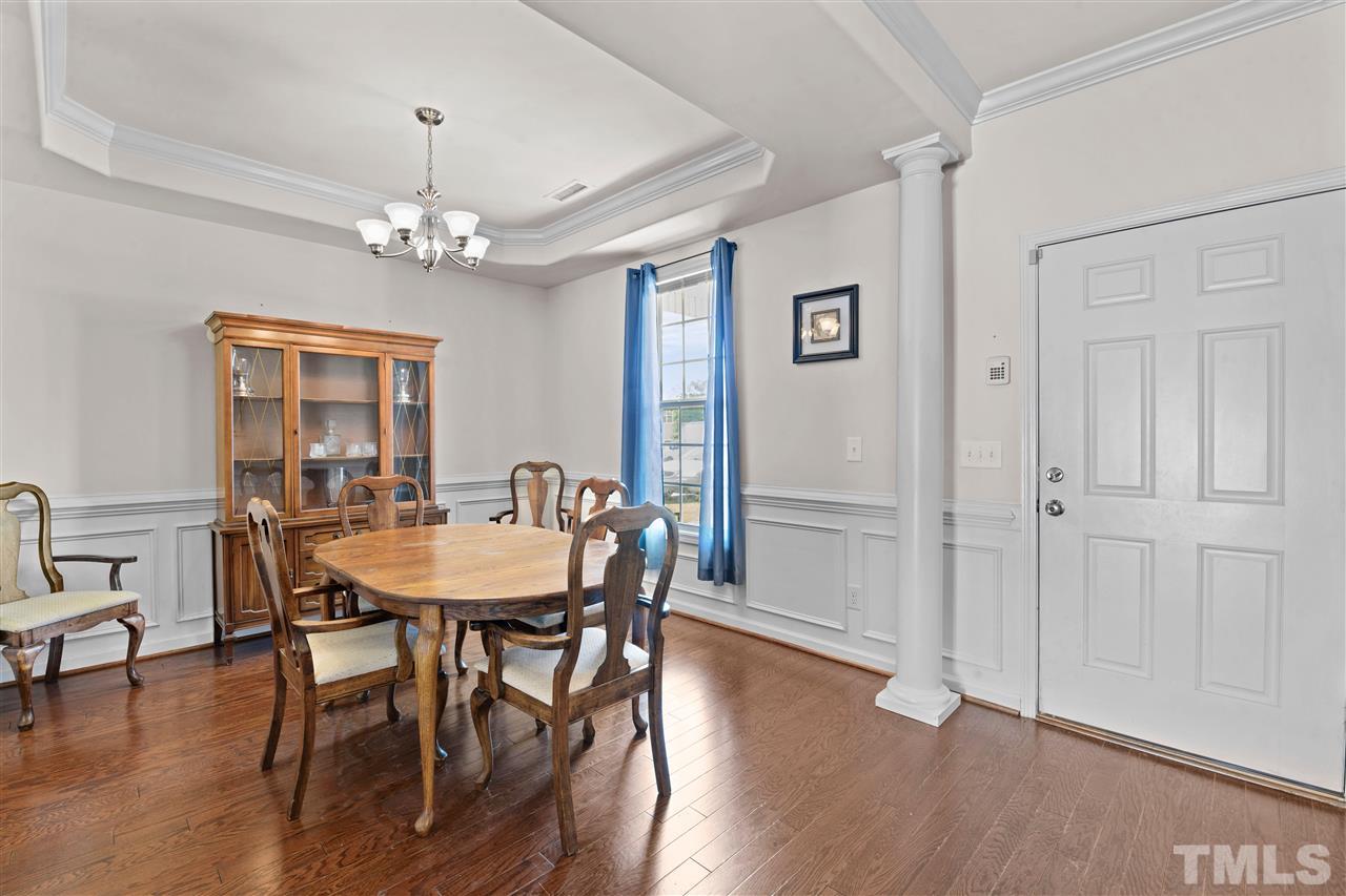 3239 Sunbright Lane Raleigh, NC 27610 - Photo 4 of 18 a view of a dining room with furniture wooden floor and chandelier