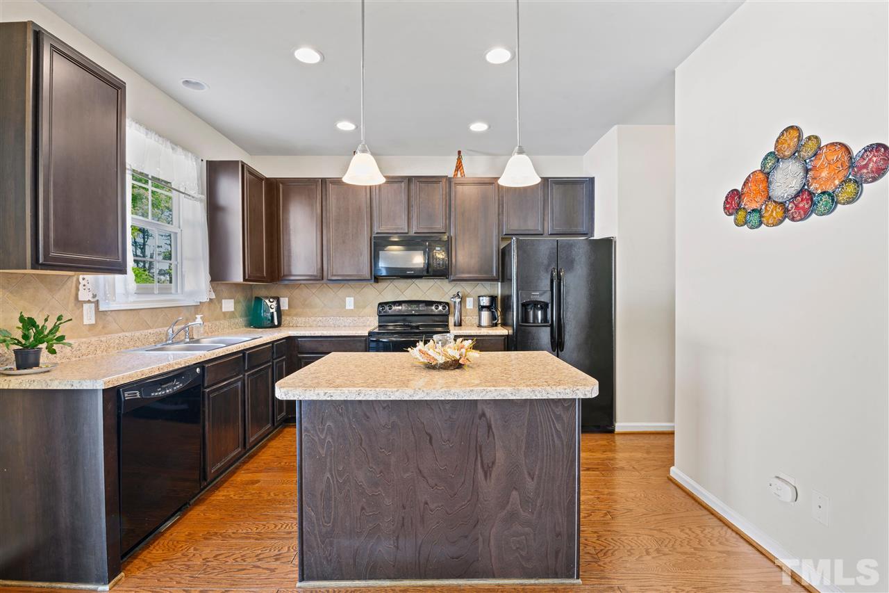 3239 Sunbright Lane Raleigh, NC 27610 - Photo 6 of 18 a kitchen with stainless steel appliances granite countertop a sink stove and refrigerator