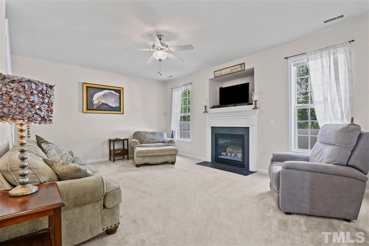 3239 Sunbright Lane Raleigh, NC 27610 - Photo 8 of 18 a living room with furniture and a fireplace