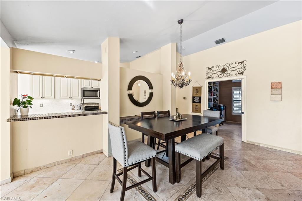 2271 Oakes Boulevard Naples, FL 34119 - Photo 12 of 47 a view of a dining room with furniture and window