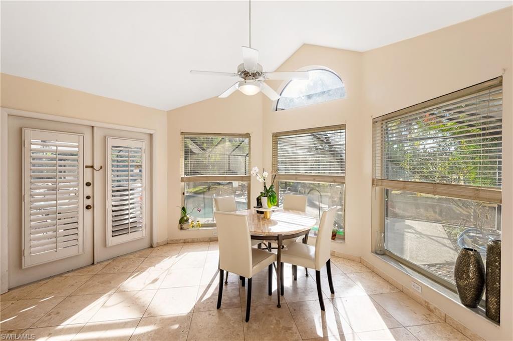 2271 Oakes Boulevard Naples, FL 34119 - Photo 16 of 47 a dining room with furniture a chandelier and a large window