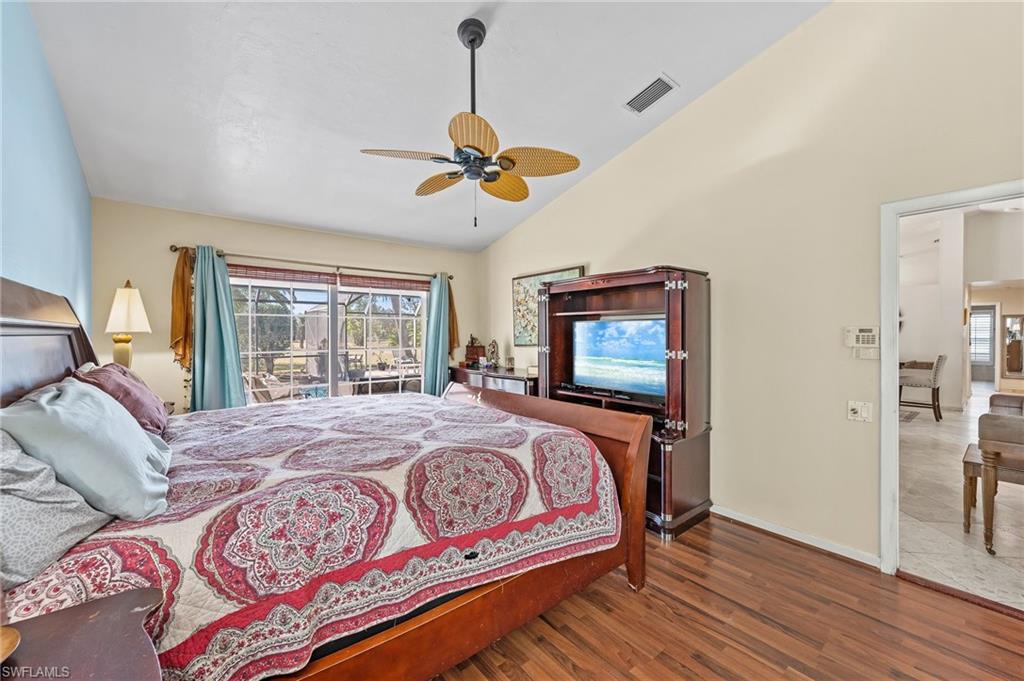 2271 Oakes Boulevard Naples, FL 34119 - Photo 21 of 47 a bedroom with a bed and wooden floor