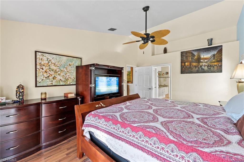 2271 Oakes Boulevard Naples, FL 34119 - Photo 22 of 47 a bedroom with a bed and a flat screen tv