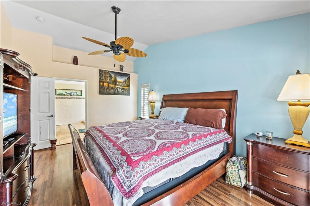 2271 Oakes Boulevard Naples, FL 34119 - Photo 23 of 47 a bedroom with a bed dresser and a flat screen tv