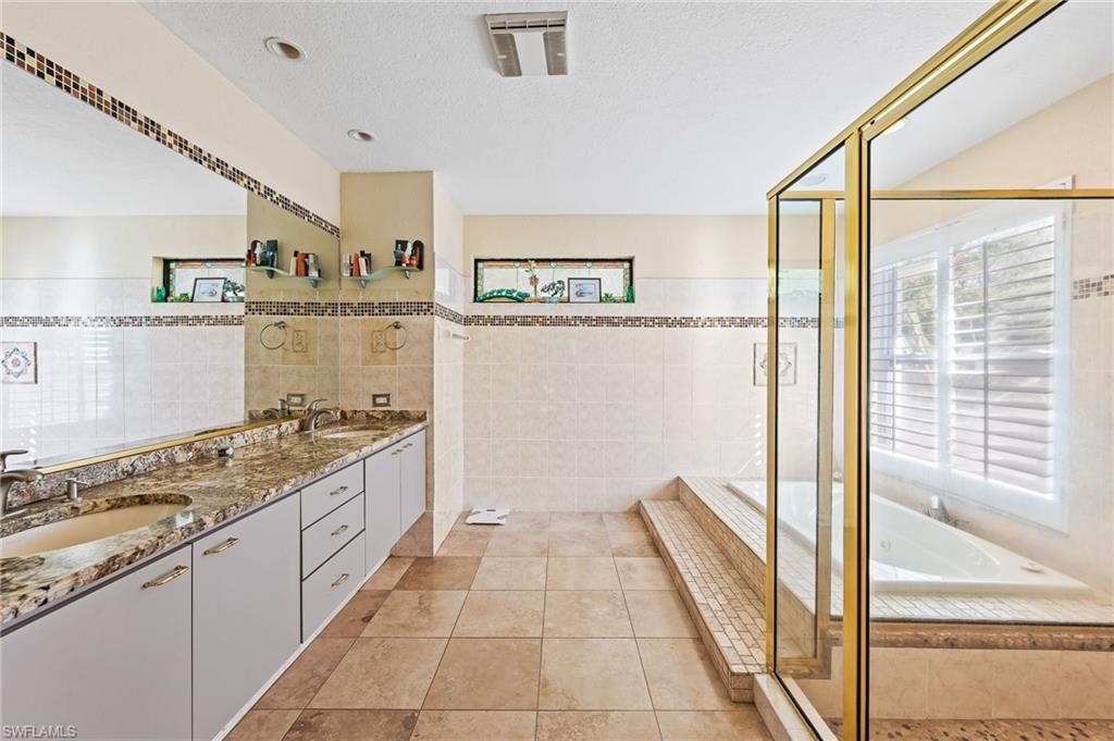 2271 Oakes Boulevard Naples, FL 34119 - Photo 24 of 47 a kitchen with stainless steel appliances granite countertop a stove and a sink
