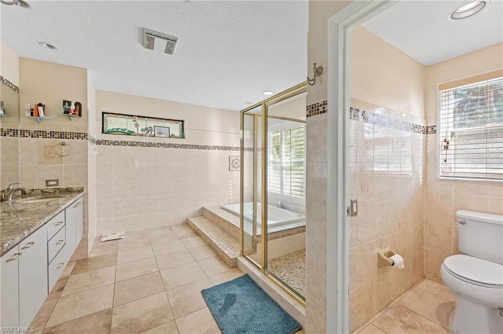 2271 Oakes Boulevard Naples, FL 34119 - Photo 25 of 47 a spacious bathroom with a granite countertop sink toilet and shower