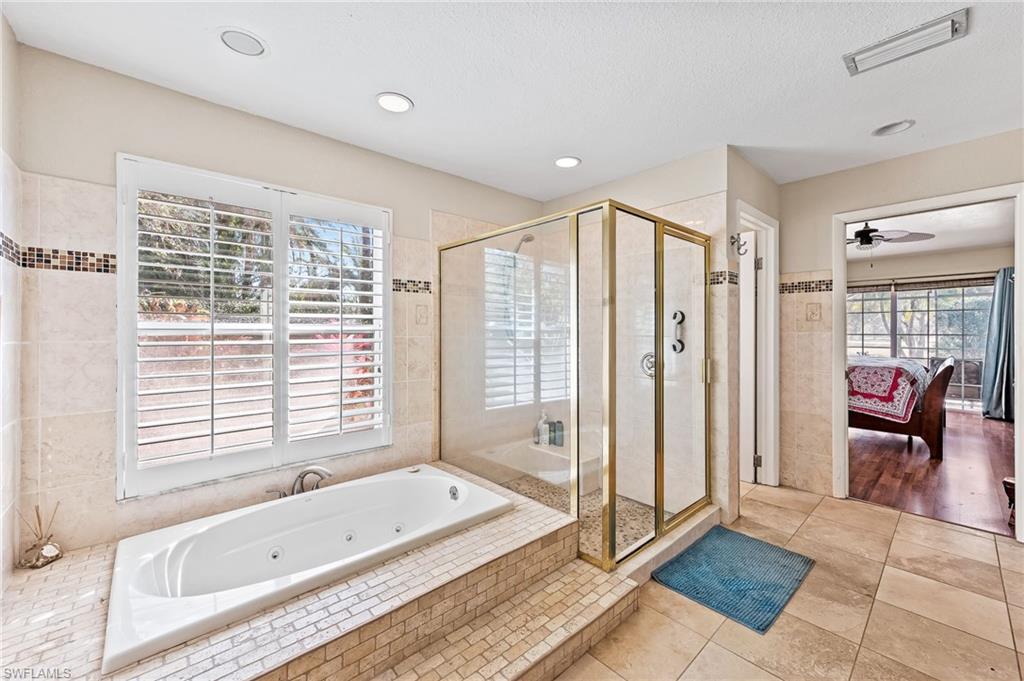 2271 Oakes Boulevard Naples, FL 34119 - Photo 27 of 47 a bathroom with a bathtub and a shower