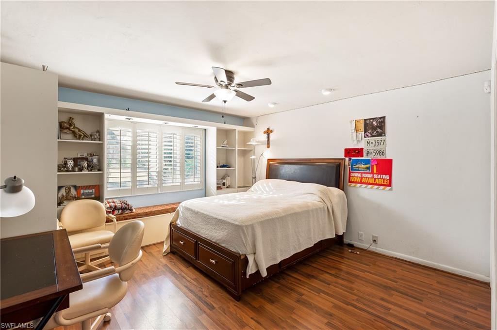 2271 Oakes Boulevard Naples, FL 34119 - Photo 28 of 47 a spacious bedroom with a bed and large windows