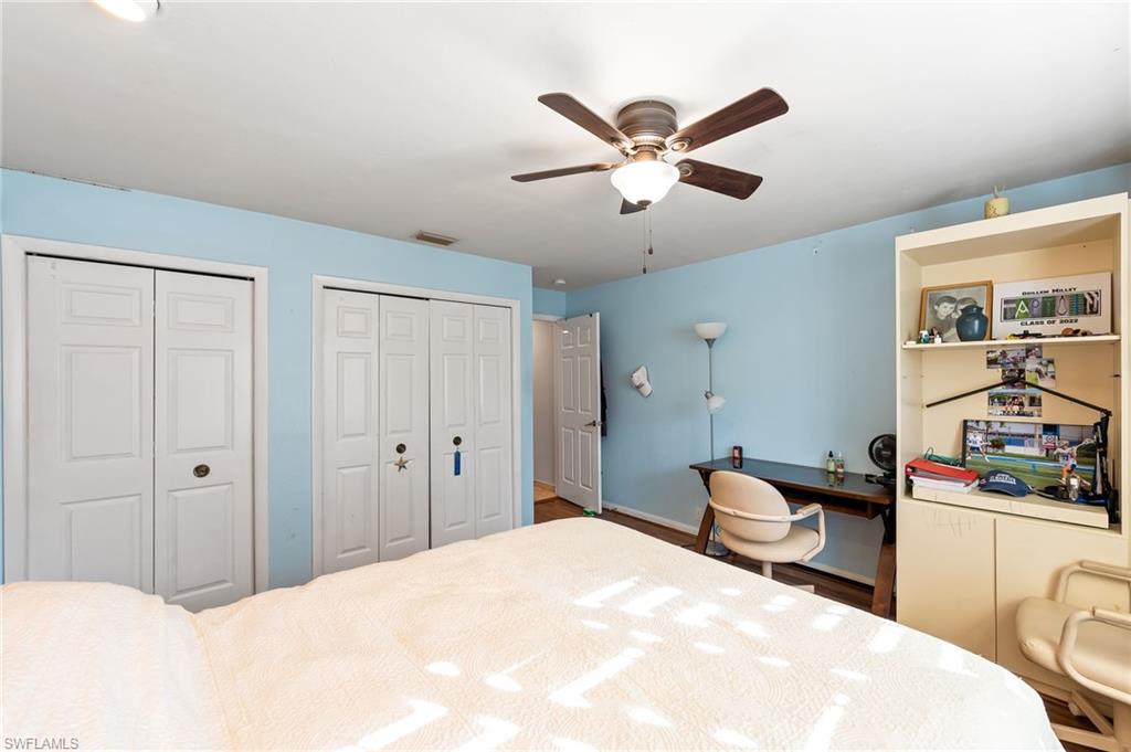 2271 Oakes Boulevard Naples, FL 34119 - Photo 30 of 47 a bedroom with a bed and a chandelier