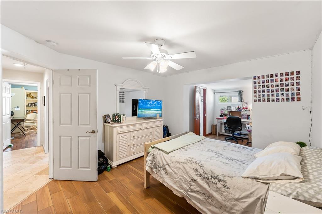 2271 Oakes Boulevard Naples, FL 34119 - Photo 33 of 47 a bedroom with a bed and ceiling fan