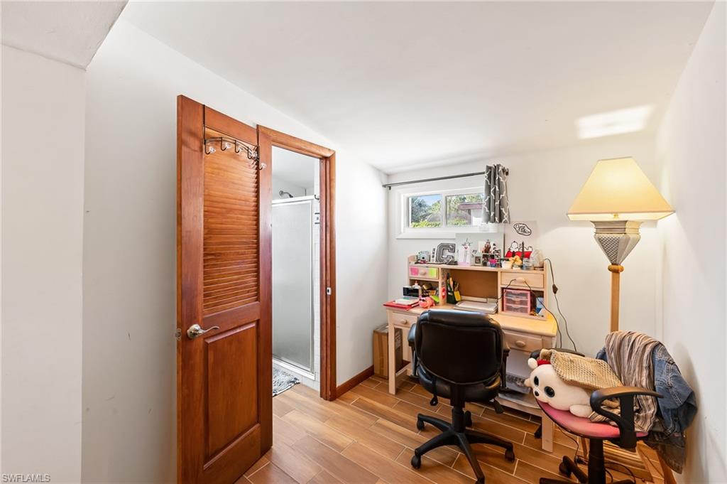 2271 Oakes Boulevard Naples, FL 34119 - Photo 35 of 47 a view of a workspace with furniture and a window