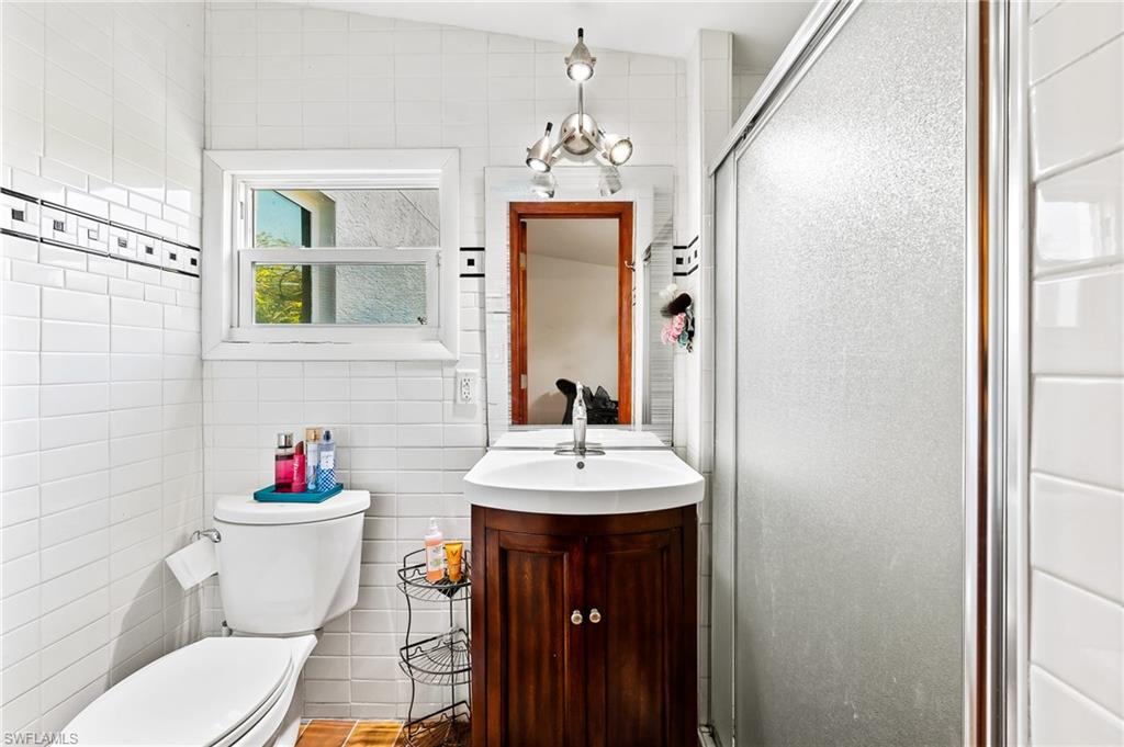 2271 Oakes Boulevard Naples, FL 34119 - Photo 36 of 47 a bathroom with a sink vanity mirror and toilet