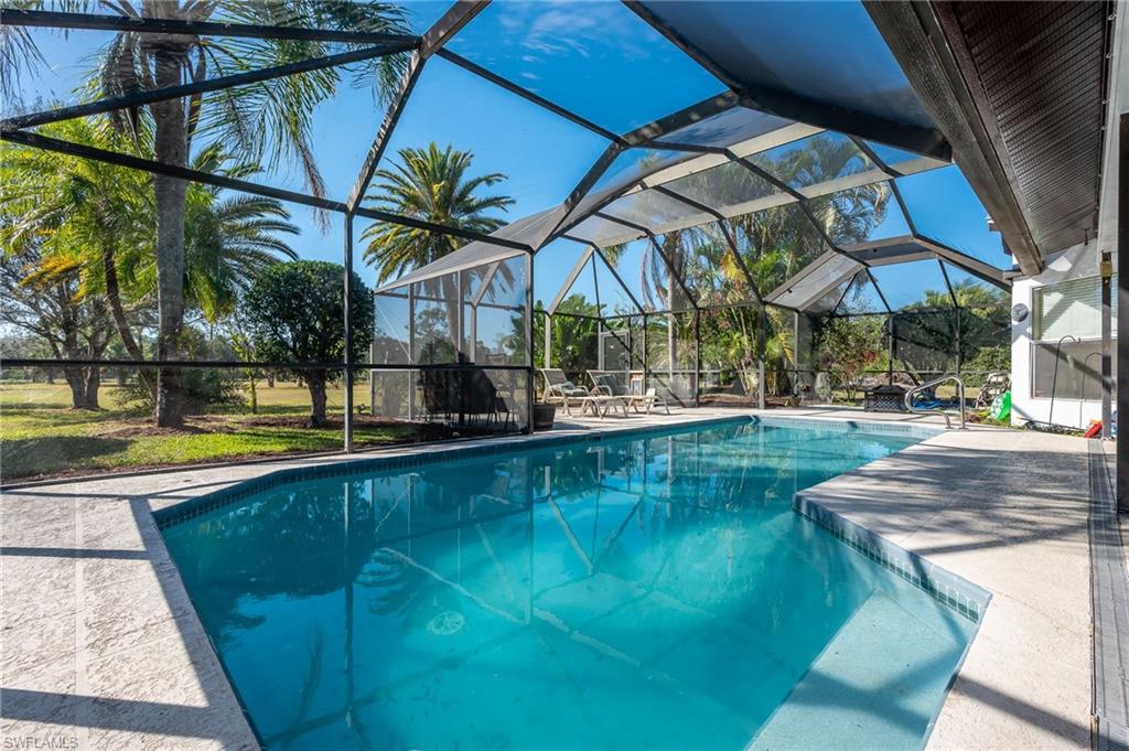 2271 Oakes Boulevard Naples, FL 34119 - Photo 37 of 47 a view of a swimming pool with a patio
