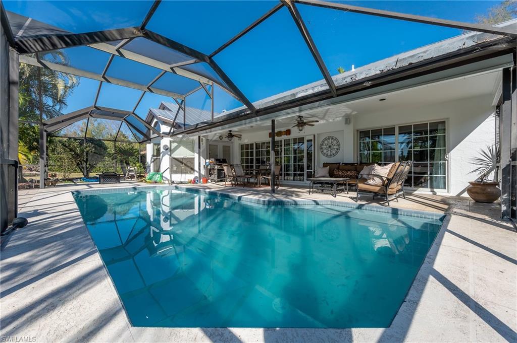 2271 Oakes Boulevard Naples, FL 34119 - Photo 38 of 47 a view of a patio with chairs and umbrellas
