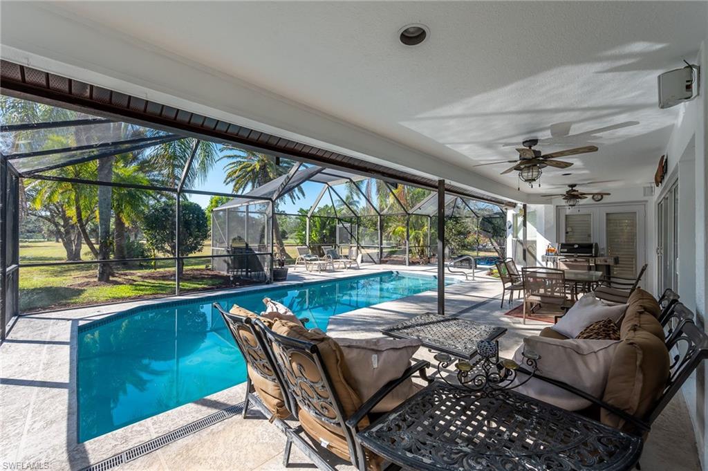2271 Oakes Boulevard Naples, FL 34119 - Photo 41 of 47 a living room with patio furniture and a floor to ceiling window