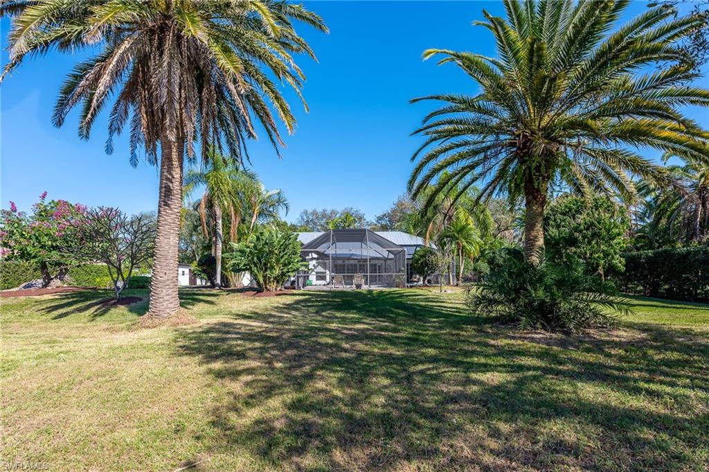 2271 Oakes Boulevard Naples, FL 34119 - Photo 42 of 47 a front view of a house with a garden