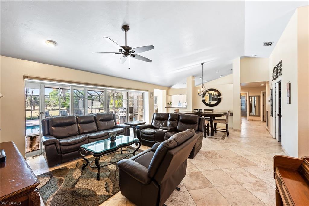 2271 Oakes Boulevard Naples, FL 34119 - Photo 6 of 47 a living room with furniture and a large window
