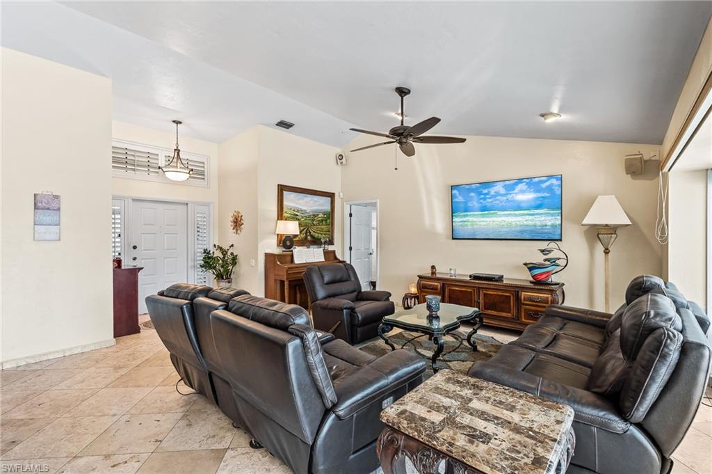 2271 Oakes Boulevard Naples, FL 34119 - Photo 7 of 47 a living room with furniture and a flat screen tv