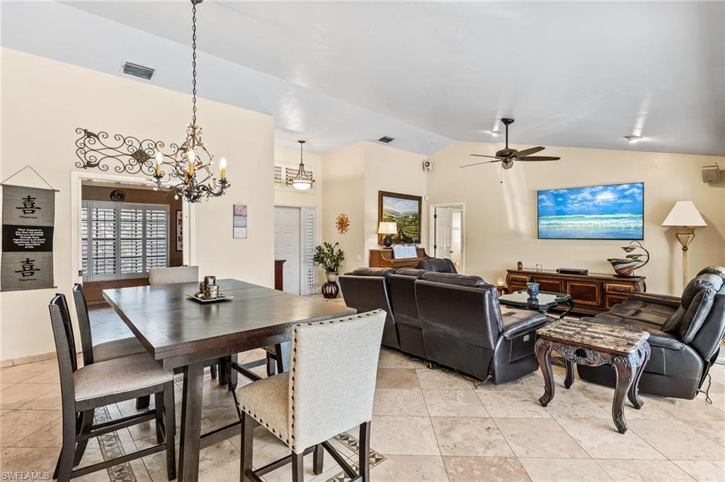 2271 Oakes Boulevard Naples, FL 34119 - Photo 9 of 47 a view of a dining room with furniture and chandelier