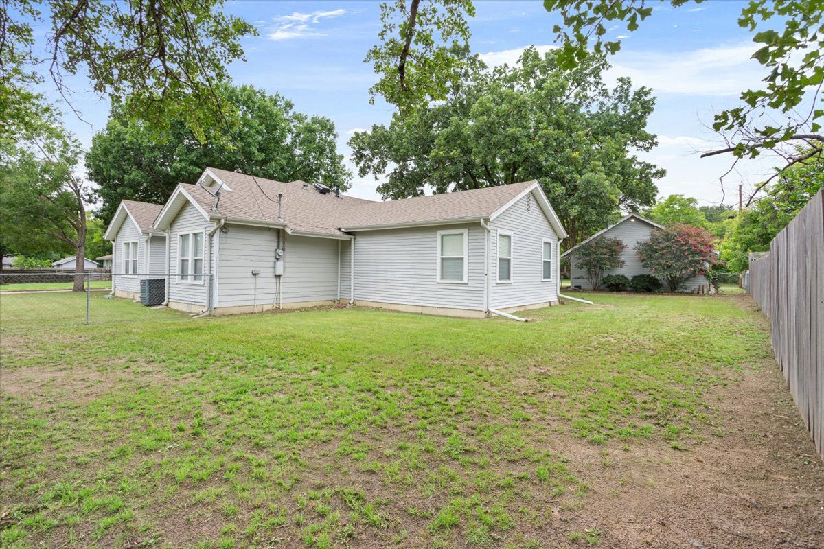 1607 North Harding Avenue Cameron, TX 76520 - Photo 36 of 37 A modest home with tidy vinyl siding and a sprawling lawn offers potential for outdoor enjoyment.