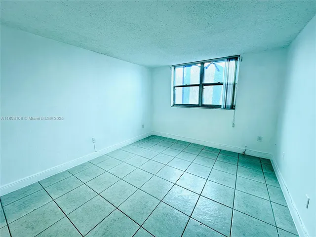 an empty room with a mirror