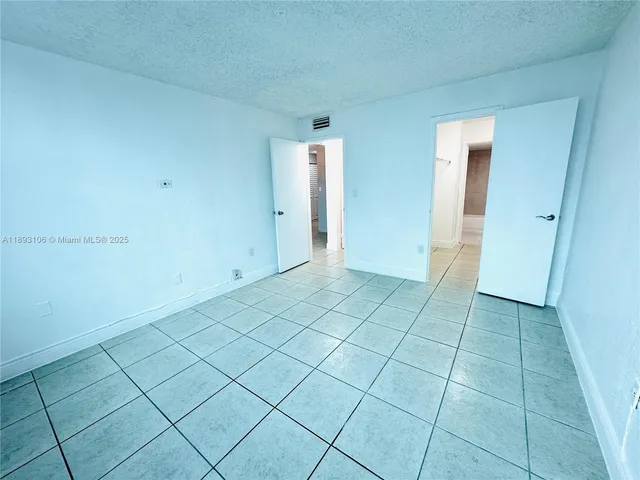 a view of a livingroom with an empty space and a window