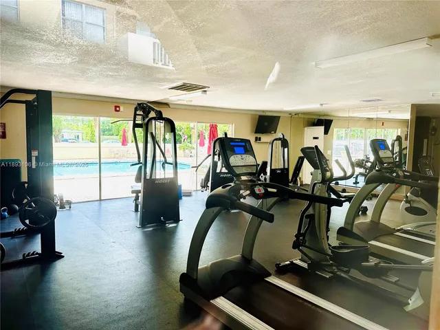 a kitchen with stainless steel appliances granite countertop a sink and a refrigerator