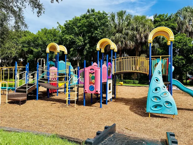 a view of park with large trees