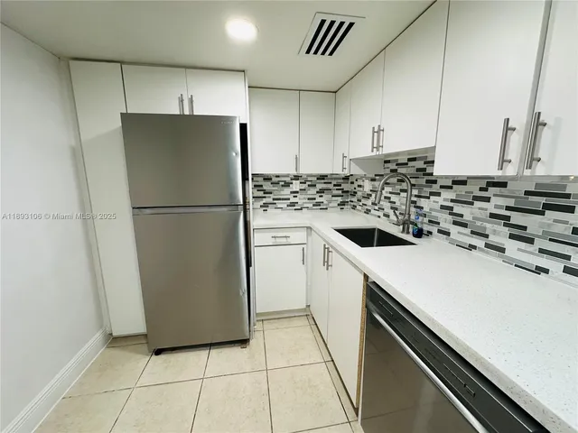 a kitchen with a refrigerator and a stove