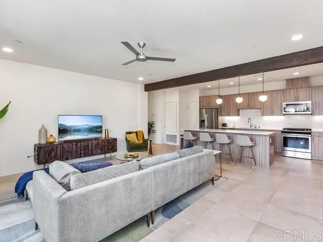 a living room with furniture and a ceiling fan