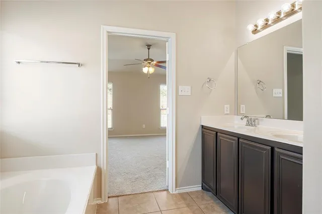 a bathroom with a double vanity sink a mirror and a shower