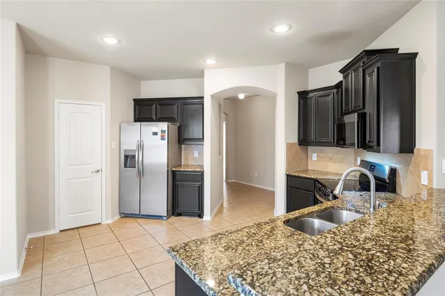 a kitchen with a sink and stainless steel appliances